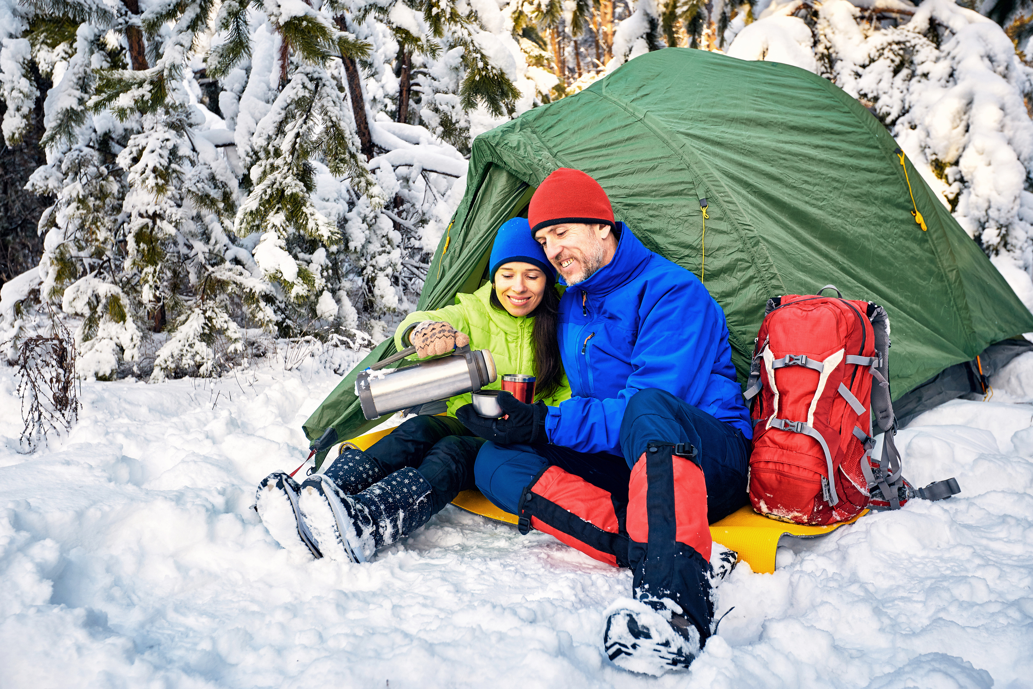 Walk through the winter forest with a backpack and tent.